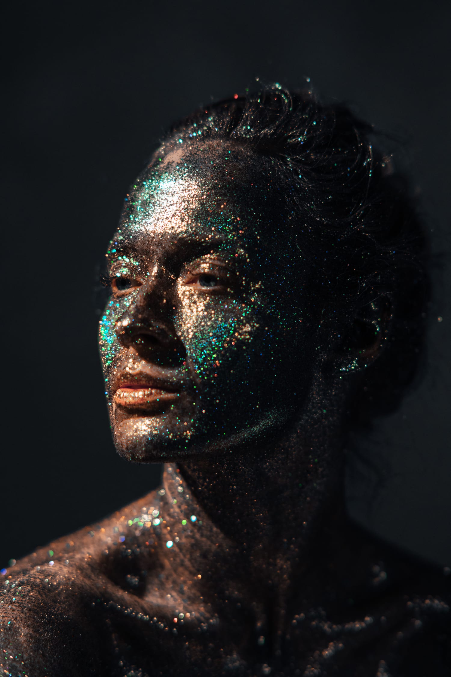 A woman's face dusted with iridescent glitter